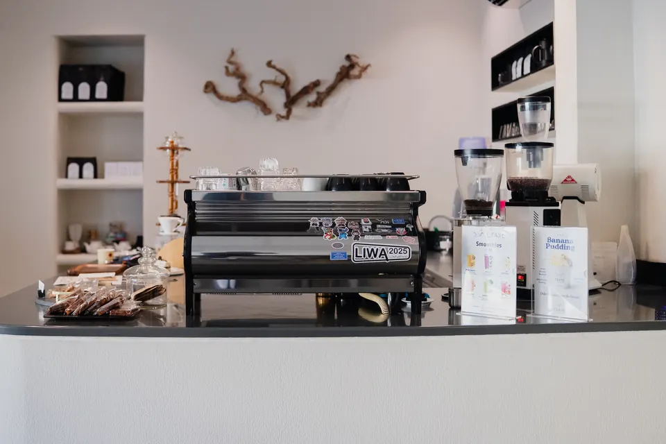 The espresso bar with its La Marzocco machine, grinders and pastry counter
