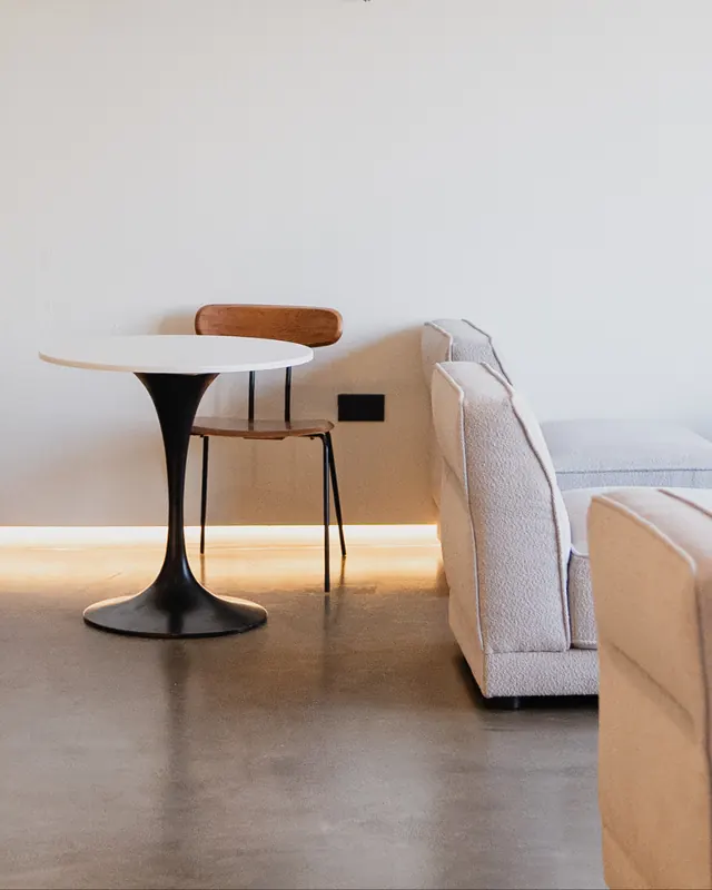A quiet corner: round table, wooden chair and a cream sofa