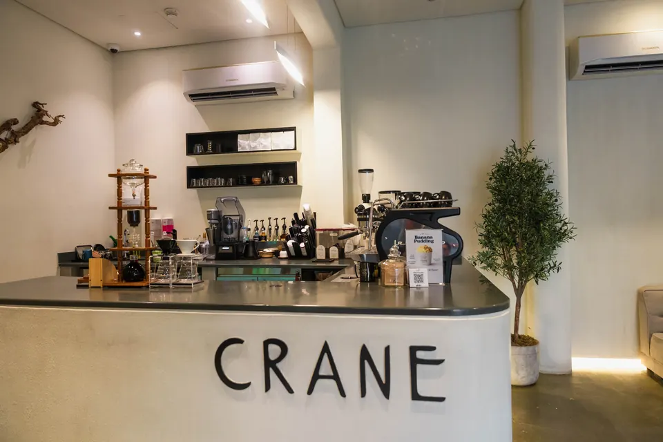 The curved white counter with CRANE lettered across the front